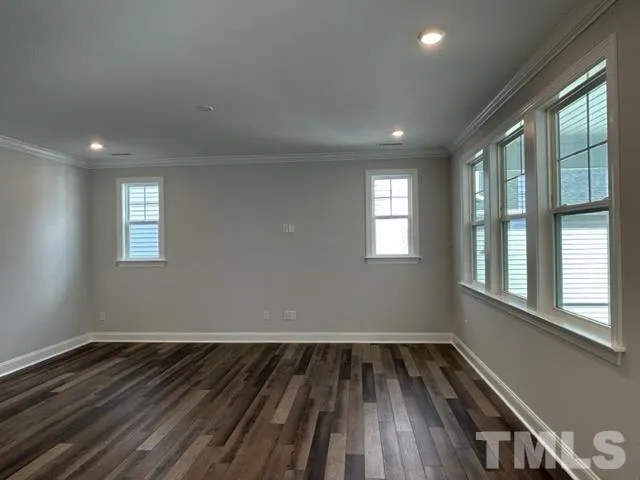 a view of wooden floor and windows in a room