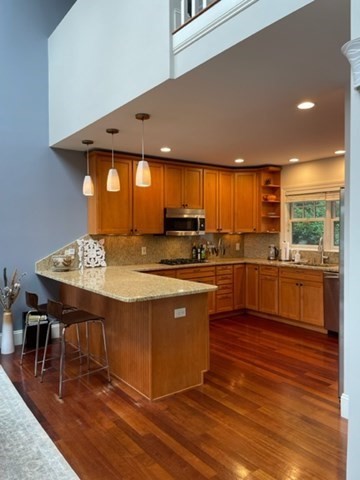 10 Shore Road Plymouth, MA 02360 - Photo 12 of 36 a kitchen with stainless steel appliances kitchen island granite countertop a stove a sink and a refrigerator