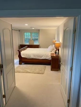 a bed sitting in a bedroom next to a window