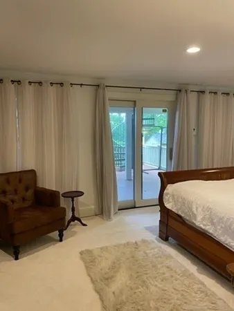 a bedroom with a bed and a couch
