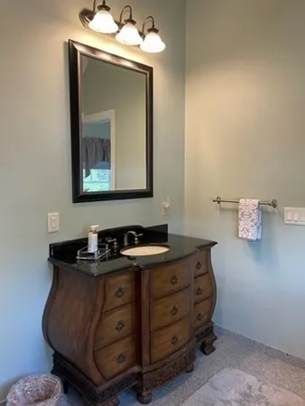 a room with a mirror and a sink
