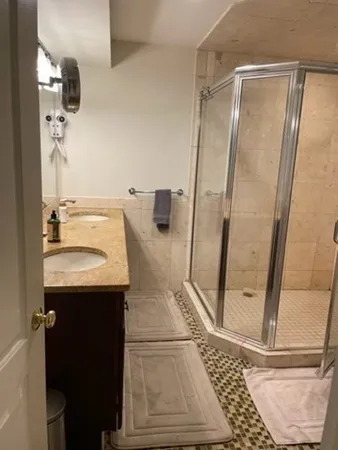 a bathroom with a sink a mirror and a shower