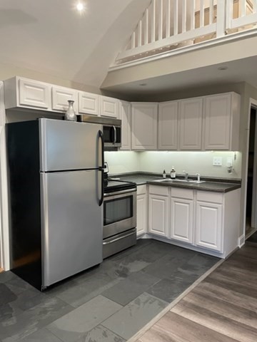 10 Shore Road Plymouth, MA 02360 - Photo 25 of 36 a kitchen with granite countertop a refrigerator and a stove
