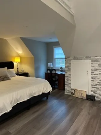 a large bed sitting in a room next to a window