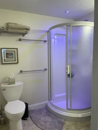 a bathroom with a toilet and a shower