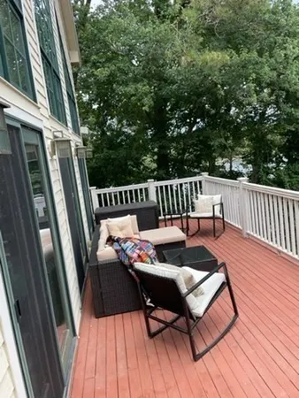 a balcony with wooden floor outdoor seating