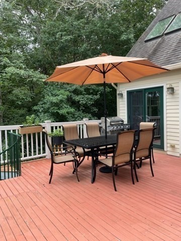 10 Shore Road Plymouth, MA 02360 - Photo 8 of 36 a patio with wooden floor a yard a table and chairs