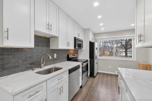 a kitchen with a sink stove and cabinets
