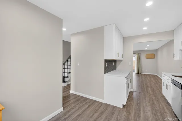 a view of hallway with wooden floor