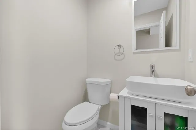 a white toilet sitting next to a bathroom sink