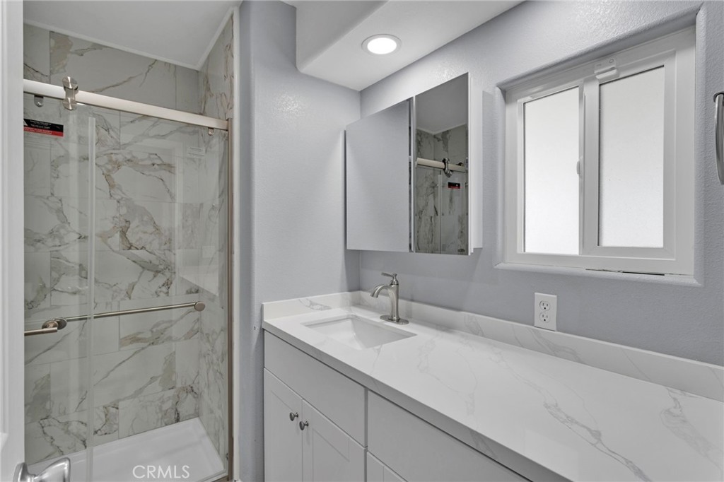 15252 Seneca Road, Unit 221 Victorville, CA 92392 - Photo 11 of 29 a bathroom with a double vanity sink mirror and shower