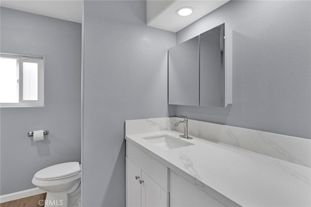 15252 Seneca Road, Unit 221 Victorville, CA 92392 - Photo 14 of 29 a bathroom with a sink toilet and vanity