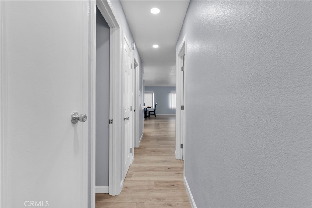 15252 Seneca Road, Unit 221 Victorville, CA 92392 - Photo 17 of 29 a view of a hallway with wooden floor and staircase