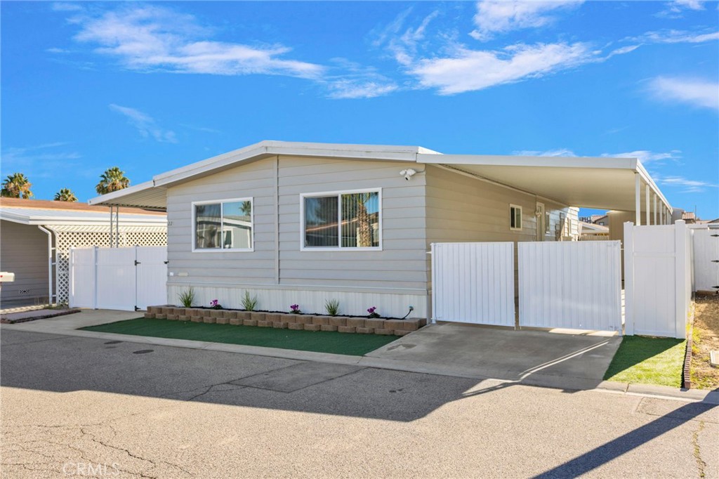 15252 Seneca Road, Unit 221 Victorville, CA 92392 - Photo 2 of 29 a front view of a house with a yard
