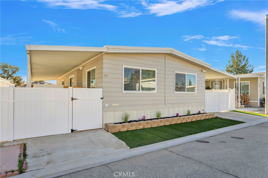 15252 Seneca Road, Unit 221 Victorville, CA 92392 - Photo 3 of 29 a front view of a house with a yard