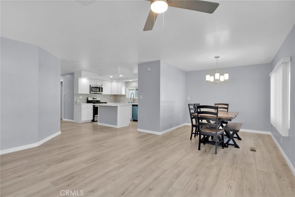 15252 Seneca Road, Unit 221 Victorville, CA 92392 - Photo 5 of 29 a view of a dining room with furniture and wooden floor