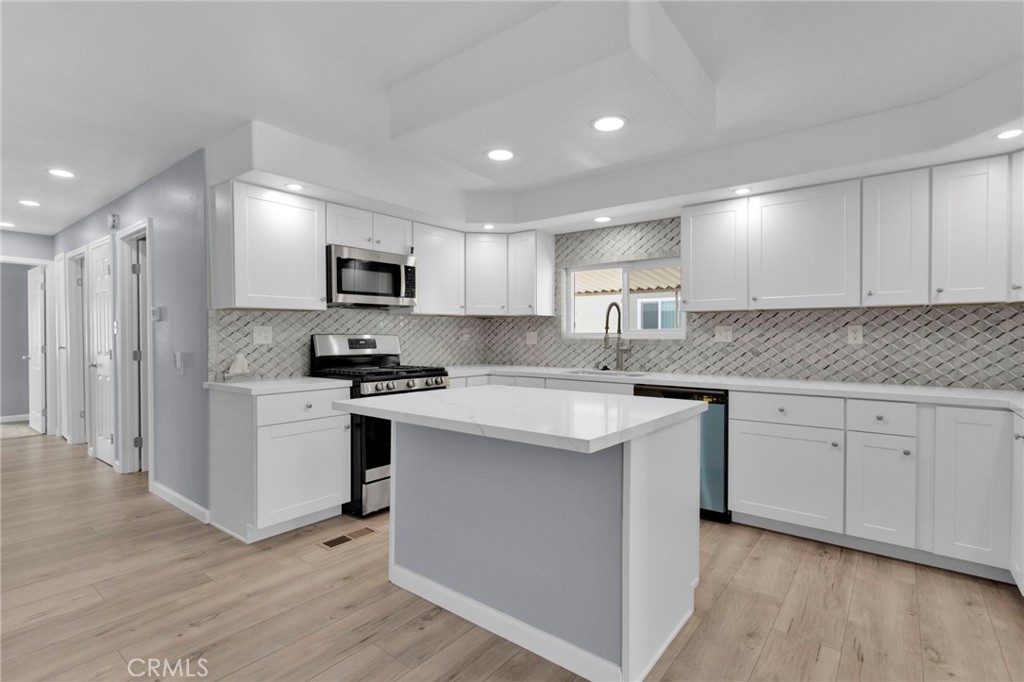 15252 Seneca Road, Unit 221 Victorville, CA 92392 - Photo 6 of 29 a kitchen with granite countertop white cabinets and stainless steel appliances