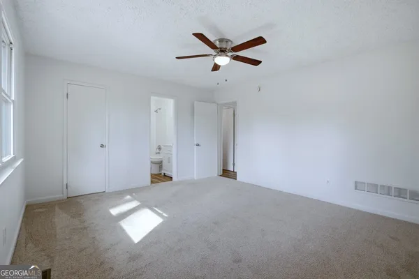 a view of a livingroom with a ceiling fan and window