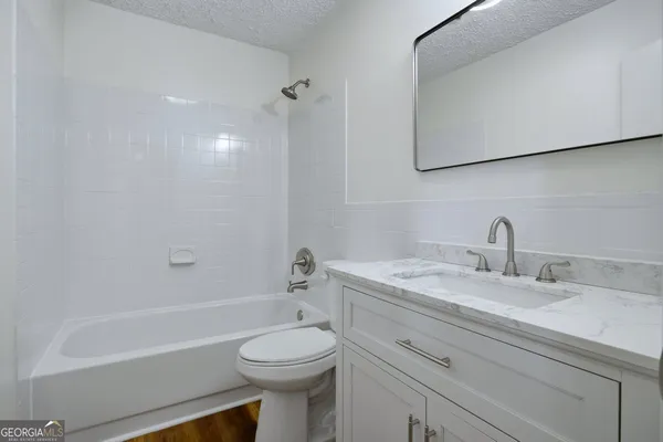 a bathroom with a sink a toilet and a bathtub