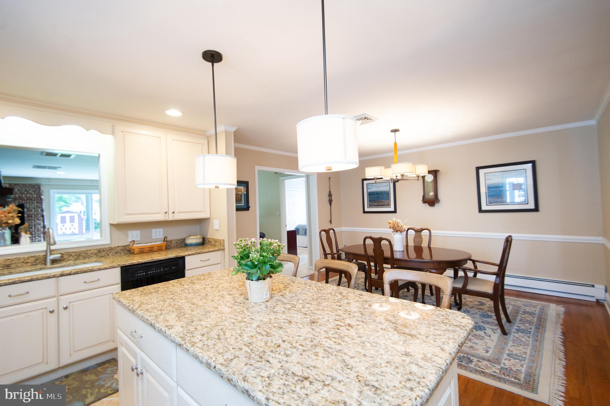 412 Talbot Avenue Cambridge, MD 21613 - Photo 11 of 32 a large kitchen with lots of counter space dining table and chairs