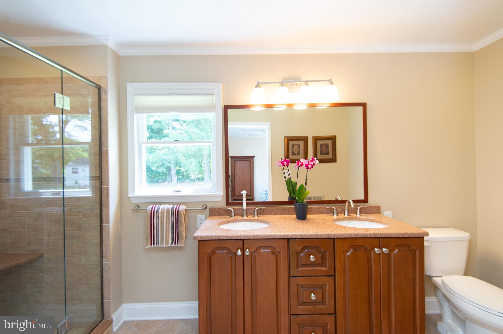 412 Talbot Avenue Cambridge, MD 21613 - Photo 16 of 32 a bathroom with a double vanity sink and a mirror