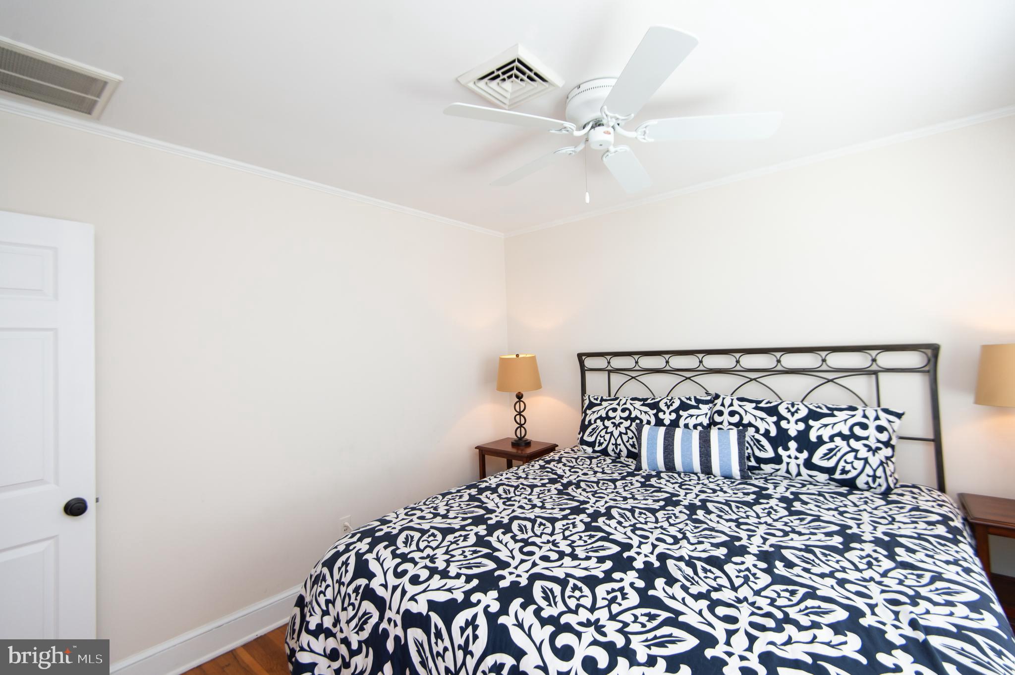 412 Talbot Avenue Cambridge, MD 21613 - Photo 23 of 32 a bedroom with a bed and a chandelier