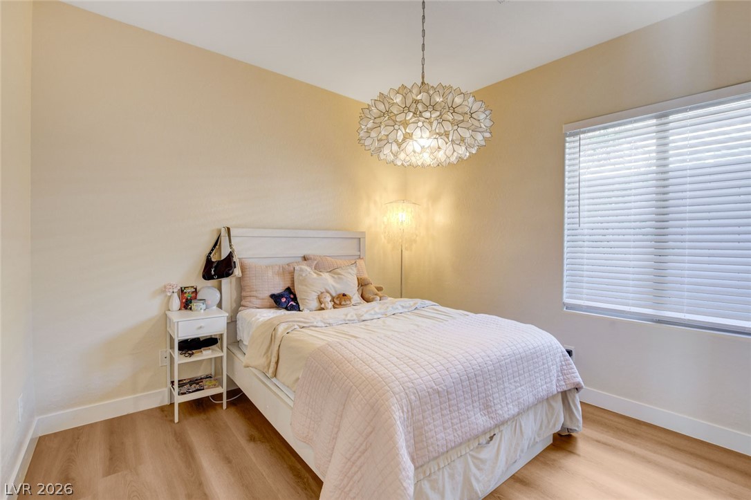 2649 Rue Marquette Avenue Henderson, NV 89044 - Photo 30 of 55 This cozy bedroom offers warm wooden flooring and abundant natural light.