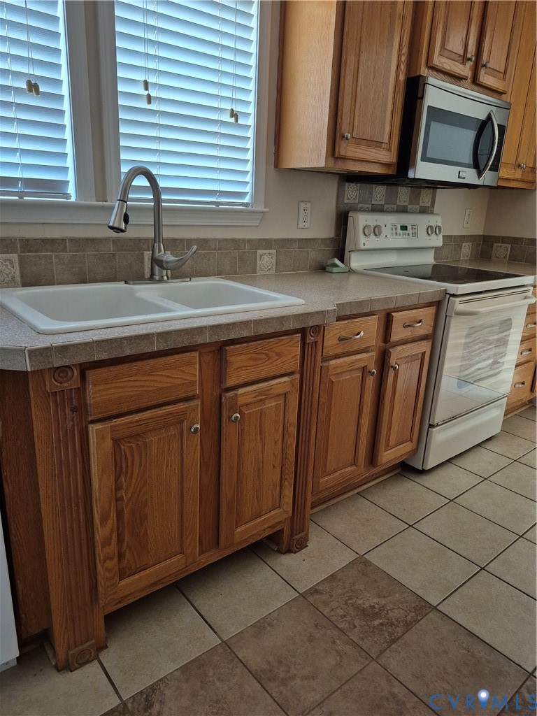 10541 Continental Road Quinton, VA 23141 - Photo 8 of 15 Kitchen featuring wood cabinetry, a dual basin sin