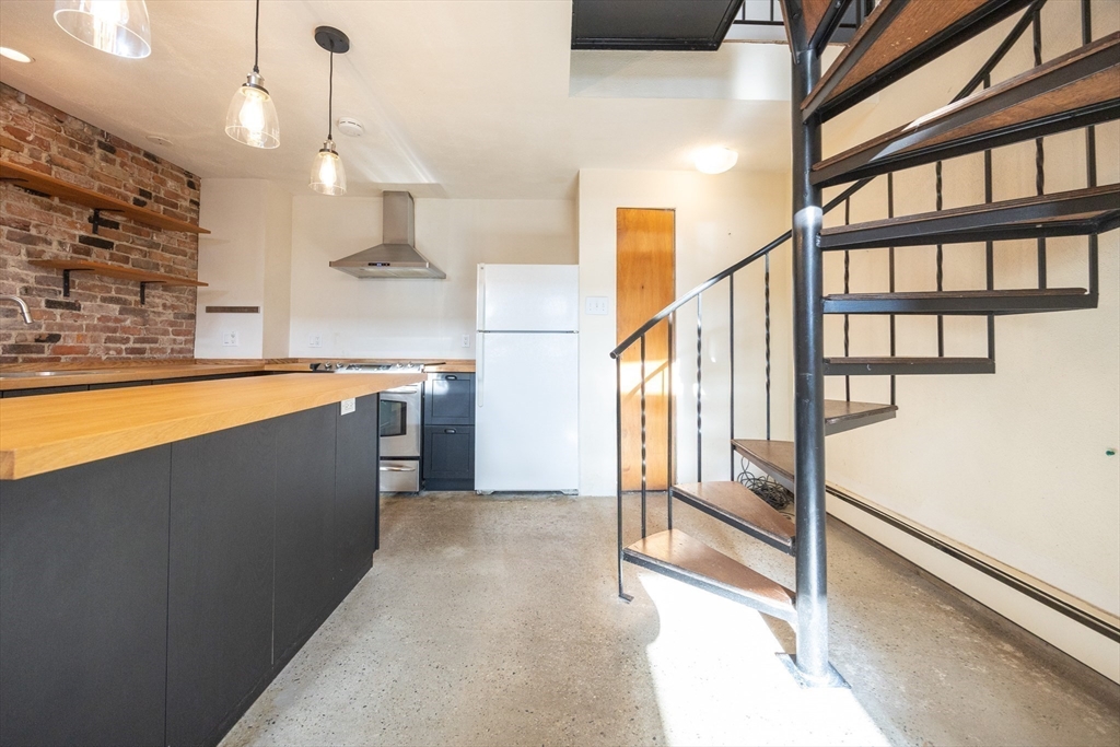 20 Beacon Street, Unit 2 Chelsea, MA 02150 - Photo 15 of 40 a view of a kitchen with a sink and a window