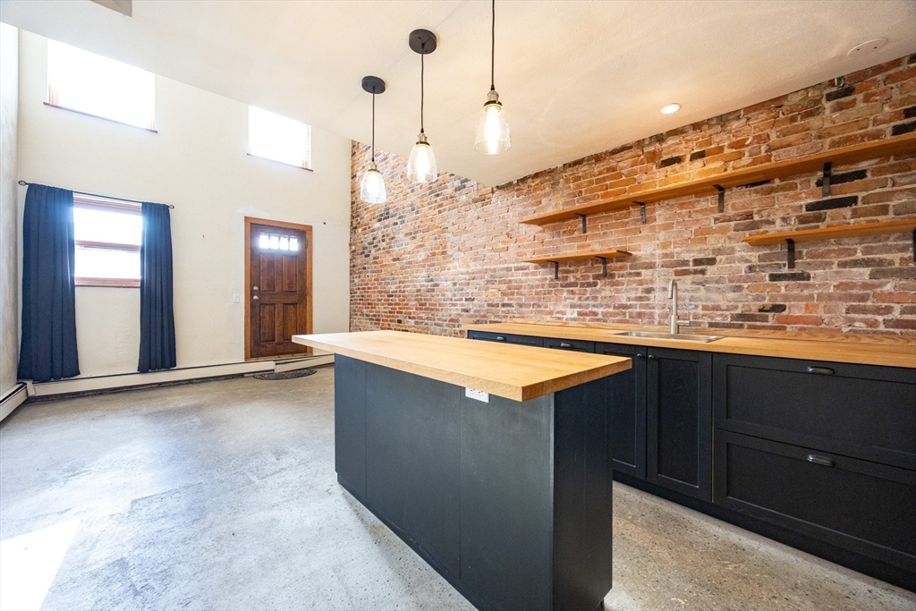 20 Beacon Street, Unit 2 Chelsea, MA 02150 - Photo 19 of 40 a view of kitchen with granite countertop a sink and a wooden floor