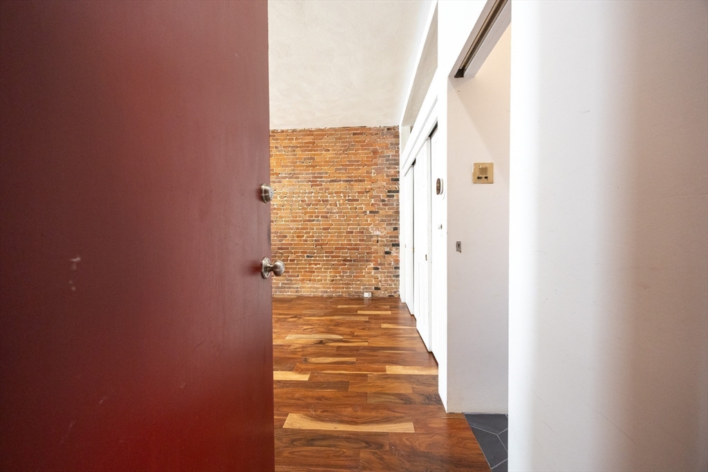 20 Beacon Street, Unit 2 Chelsea, MA 02150 - Photo 23 of 40 a view of a hallway with wooden floor and a bathroom