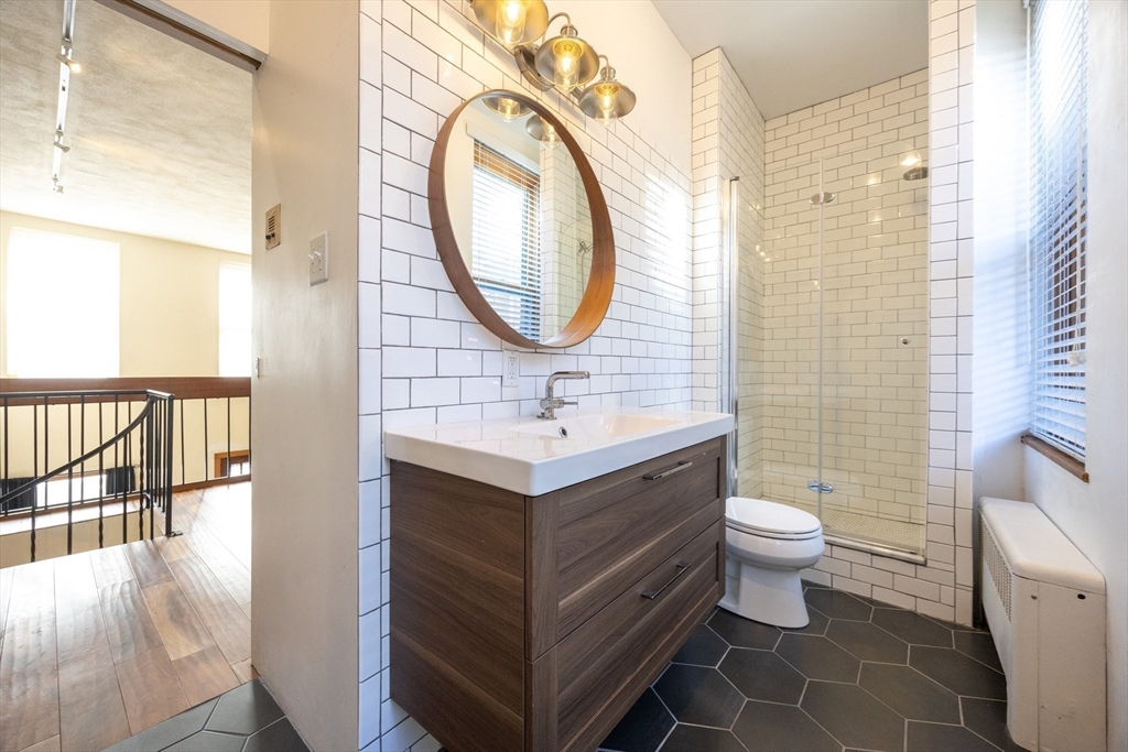 20 Beacon Street, Unit 2 Chelsea, MA 02150 - Photo 30 of 40 a bathroom with a sink mirror vanity and toilet