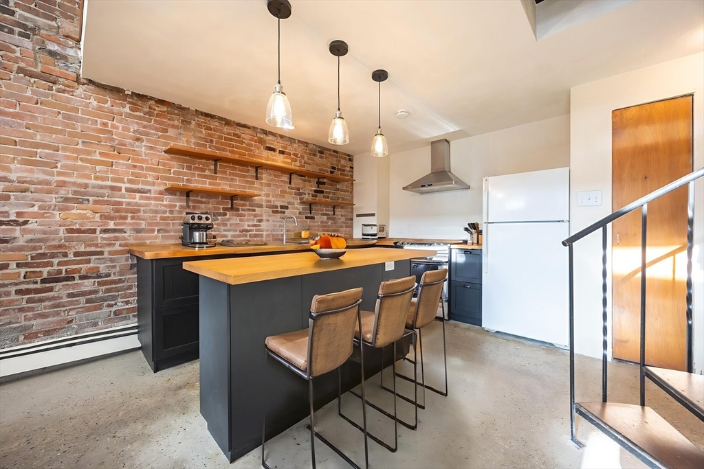20 Beacon Street, Unit 2 Chelsea, MA 02150 - Photo 3 of 40 a kitchen with stainless steel appliances granite countertop a sink a stove and a refrigerator