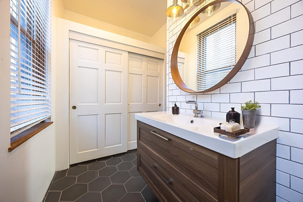 20 Beacon Street, Unit 2 Chelsea, MA 02150 - Photo 5 of 40 a bathroom with a sink and a mirror