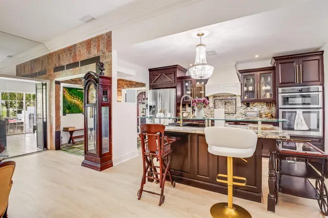 a dining room with wooden floor and furniture