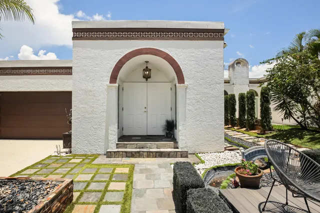 a front view of a house with garden