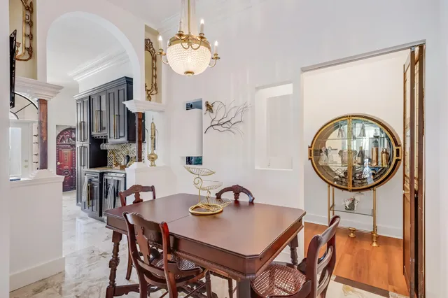 a view of a dining room with furniture and a chandelier