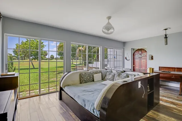 a bed sitting in a bedroom next to a window