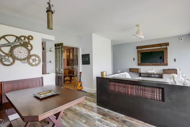 a living room with furniture and flat screen tv