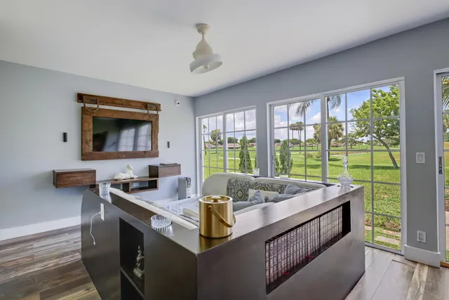 a dining room with furniture and a window