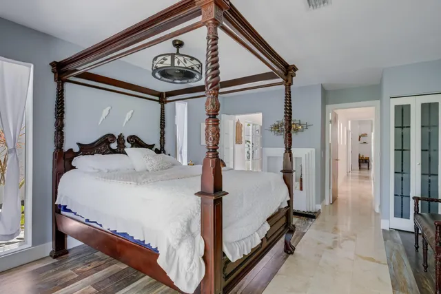 a bed room with a bed and a ceiling fan