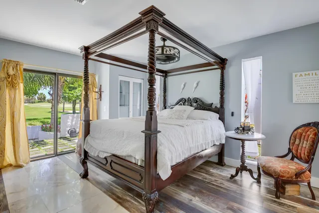 a bed sitting in a bedroom next to a window