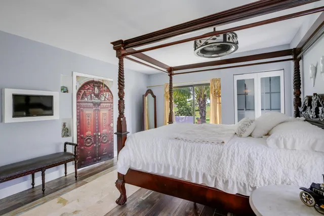 a bedroom with a bed and a chandelier