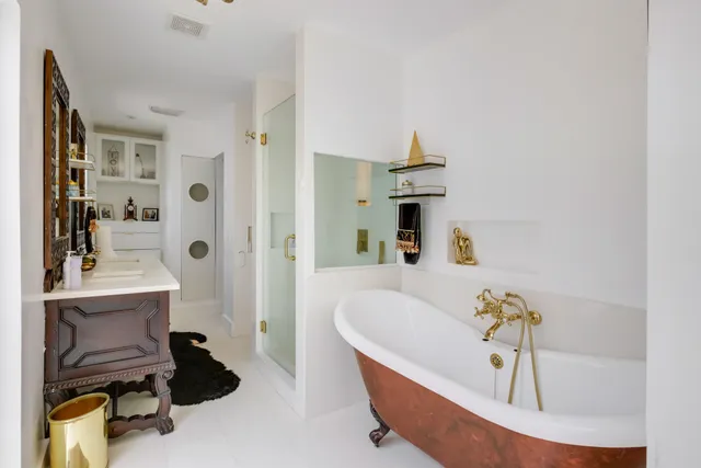 a bath tub sitting next to a bathroom sink