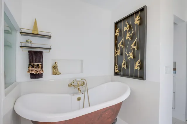 a bath tub sitting next to a white sink and vanity
