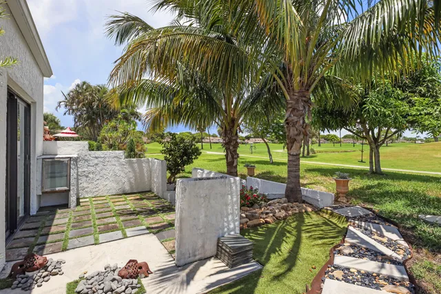 a view of a house with a yard and garden