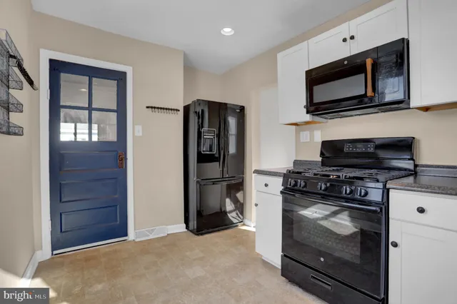 a kitchen with a refrigerator stove and microwave