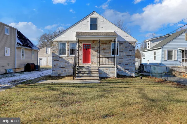 a view of a house with a big yard and large tree