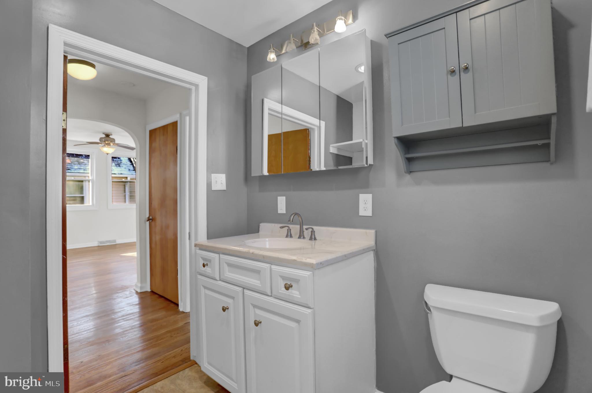 9036 Simms Court Parkville, MD 21234 - Photo 23 of 52 a bathroom with a toilet sink and mirror