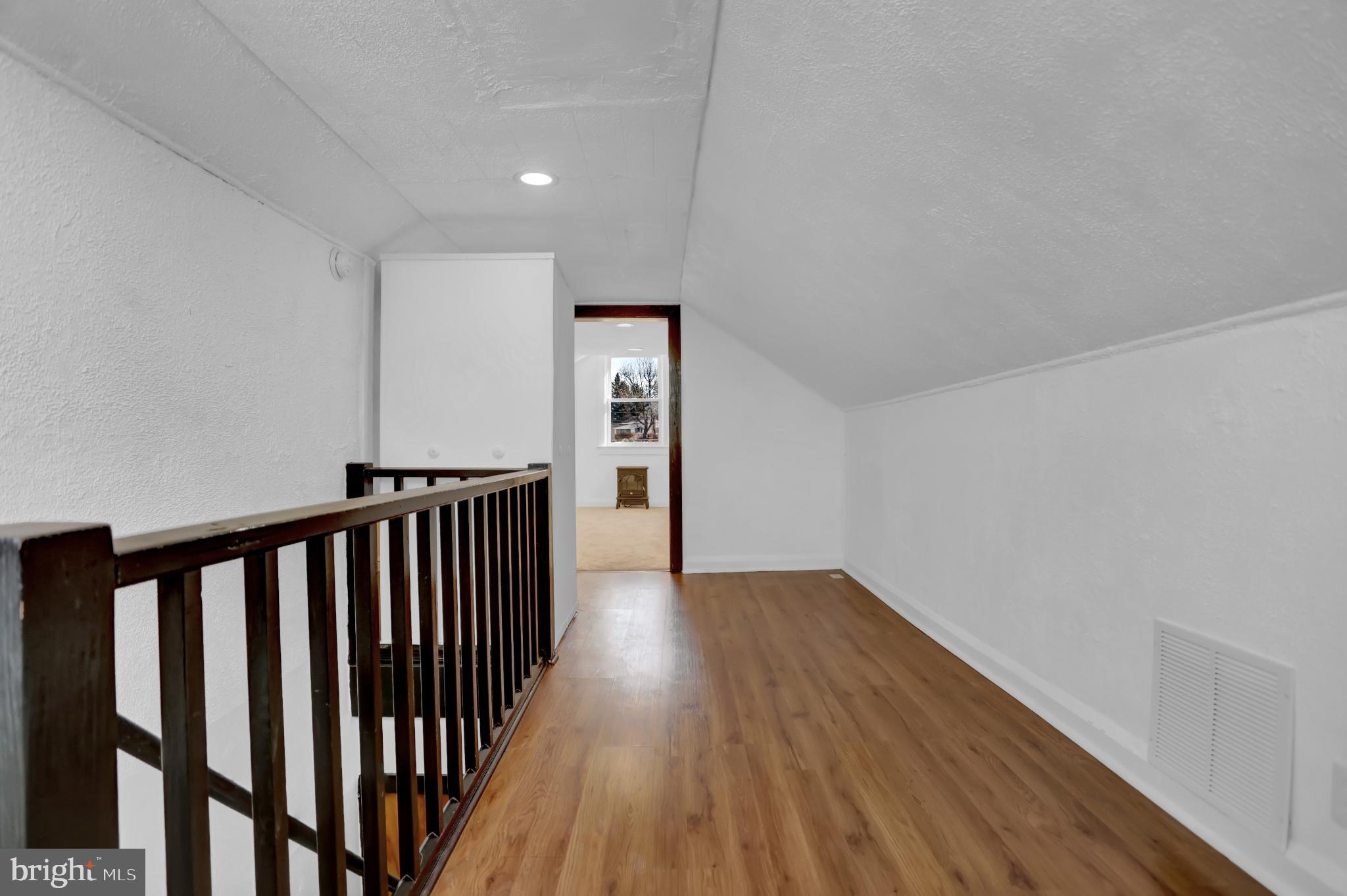 9036 Simms Court Parkville, MD 21234 - Photo 29 of 52 a view of a hallway with wooden floor